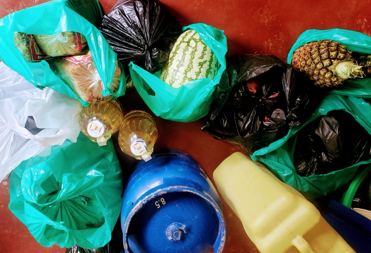 Food supplies prepared for missionary feeding and community support -- fruits, oil, and staples